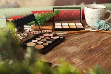 Set of cosmetics with decor for Christmas gifts on wooden table