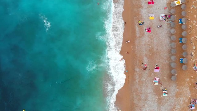 Aerial top view of sandy seashore and sandy beach with people. Europe, Spain, Valencian Country,  Province of Alicante,  Costa Blanca,  Benitachell, Cala del Moraig, Summer 2018