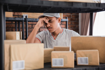 stressed young man checking packages