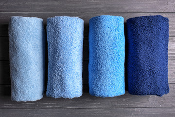 Clean soft towels on dark wooden table