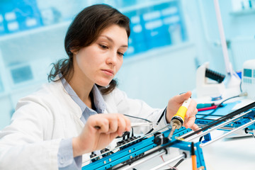 Young woman in CNC and robotics laboratory