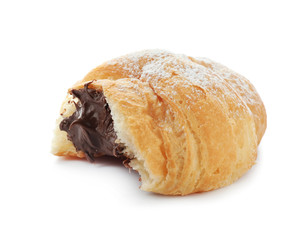 Piece of tasty croissant with chocolate on white background