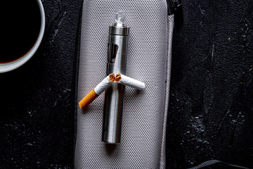 concept of electronic cigarette on dark background top view