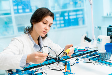 Young woman in CNC and robotics laboratory