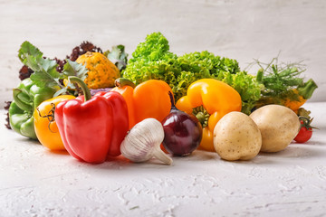 Different fresh vegetables on light background