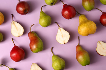 Tasty ripe pears on color background