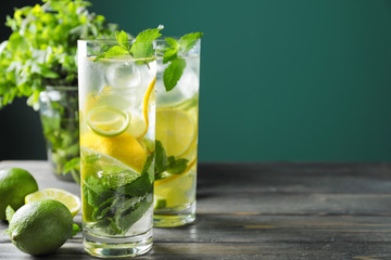 Glasses of fresh mojito on wooden table