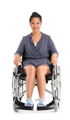 Asian woman in wheelchair on white background