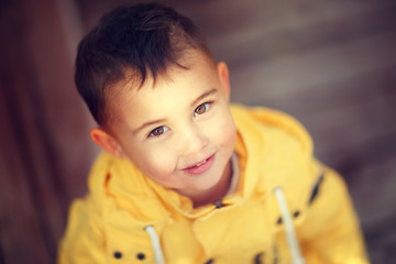 boy looking at the camera standing on the stairs