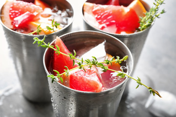 Glasses of refreshing grapefruit lemonade on table, closeup