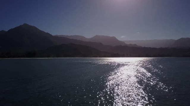 Strong into sunlight at Hanalei bay Hawaii tropical paradise. drone from above