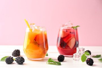 Fresh summer cocktails in glasses on white wooden table