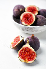 Fresh ripe figs on white table