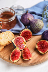 Cut ripe figs on wooden board