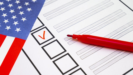 Voting in paper ballot by red pencil in United States of America wirh USA flag