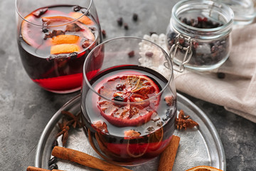 Glass of delicious mulled wine on metal tray