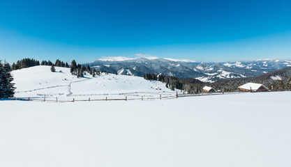 Fototapeta na wymiar Winter snowy mountains, and lone farmstead