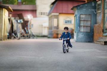 boy riding bicycle in old town