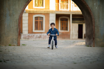 boy riding bicycle in the town