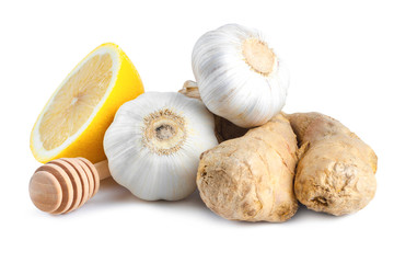 Isolated. Garlic, ginger,  lemon and honey spoons on a white background. Maintenance of immunity....