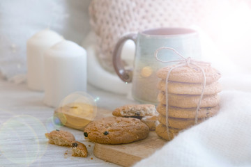 cozy winter still life: warm woolen knitting, hot tea, red book, Christmas cookies and music. Headphones. Hygge style. Cozy winter home morning holiday. Soft photo