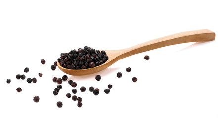 Black pepper in wooden spoon isolated on white background