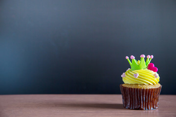 Cup cake and happy birthday text candle  on  cupcake ..Birthday cupcake with a happy brithday text...