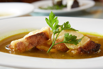 Onion soup in the ceramic pot. Shallow dof.