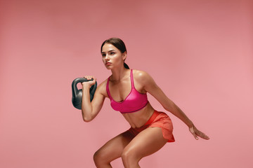 Workout. Woman Training With Dumbbell On Pink Background