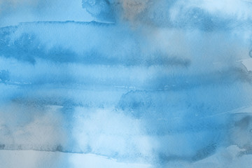 Obraz premium Blue winter watercolor ombre leaks and splashes texture on white watercolor paper background. Painted ice, frost and water.
