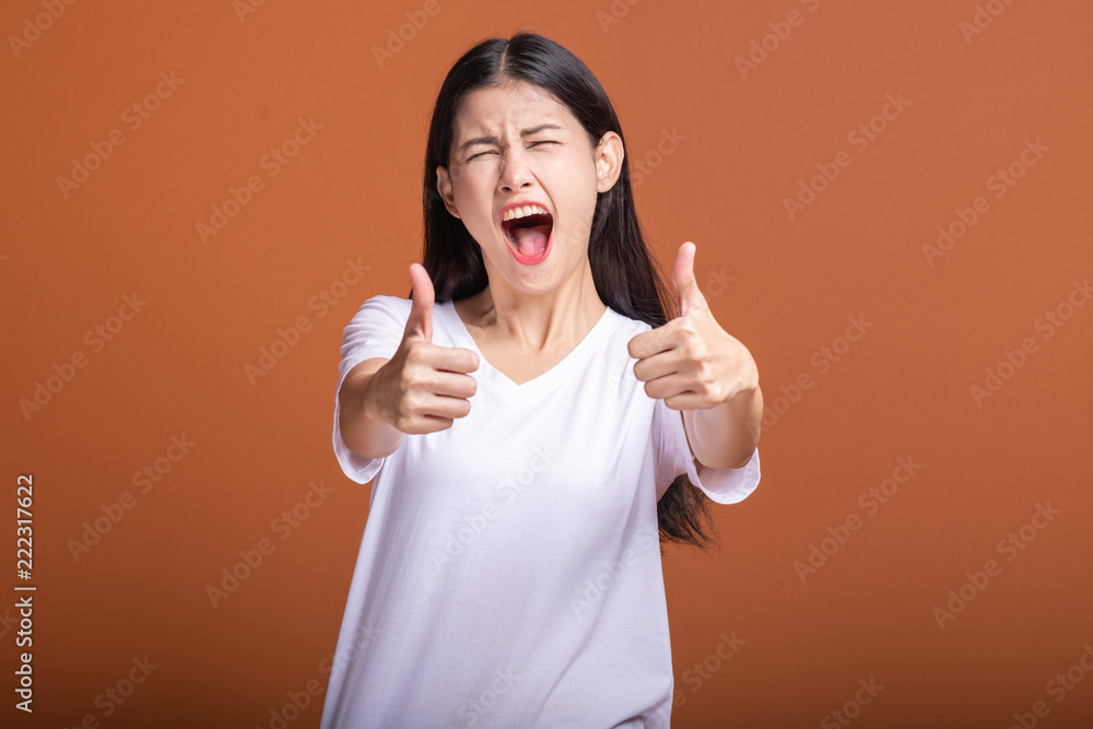 Wall mural Winning woman isolated over orange background.