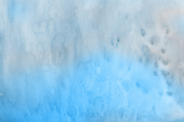 Blue winter watercolor ombre leaks and splashes texture on white watercolor paper background. Painted ice, frost and water.