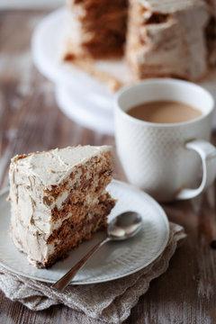 ePiece of crispy coffee and nut meringue cake with butter cream frosting