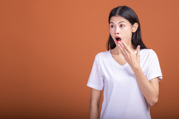 Surprise woman over orange background.