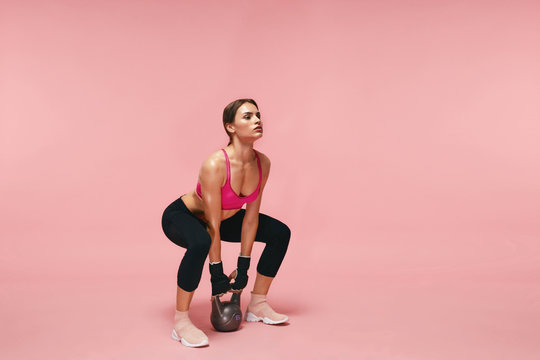 Premium Photo  Sports girl doing exercises on a pink background