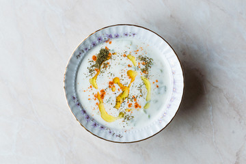 Cacik / Tzatziki Sauce with Yogurt, Cucumber Slices, Olive Oil, Thyme and Red Pepper Powder in Ceramic Bowl.