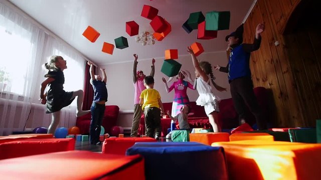 Children and animators fun throw the dice up. Animators entertain children. A children's party.