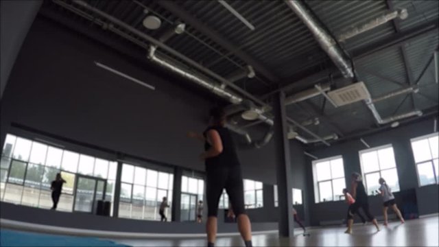 Woman training doing cardio exercise tai-bo in gym in sport club