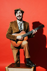 Fototapeta premium positive guy playing guitar in the Studio