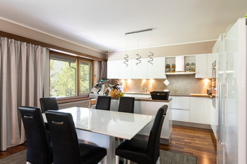 Large kitchen with leather table and chairs