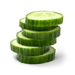 Fresh cucumber slices, isolated on white background. Close up shot of cucumber, arrangement or pile.
