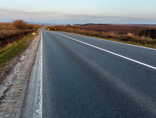 Road through the spring morning fields and countryside.