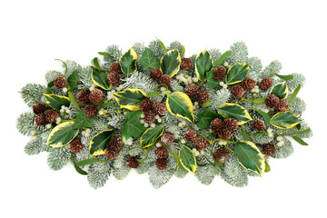 Natural winter flora decoration with snow covered pine, ivy leaf sprigs, mistletoe and pine cones...