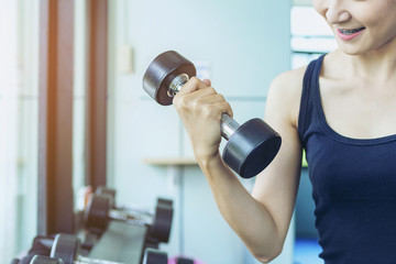Fototapeta na wymiar fitness girl exercising with barbell in gym. Determined sportswoman training on exercise equipment