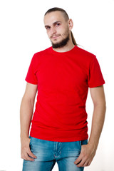 Obraz premium Young handsome guy in a red t-shirt on a white background
