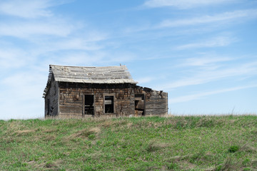 Abandoned old farmhouse in a field 