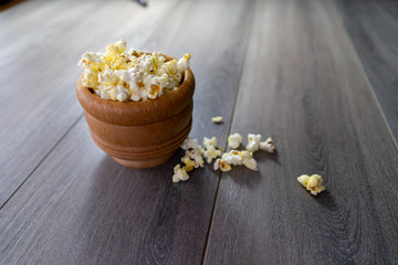 Popcorn in a mortar with pestle  on wood table 