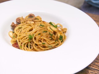 Italian cuisine, Spicy spaghetti with pork sausage and garlic in white bowl