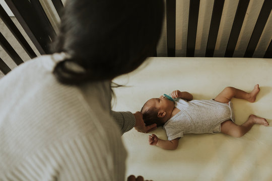 Mother Looking After A Sleeping Baby