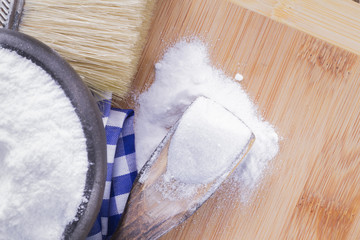 baking soda and brush are the wooden table